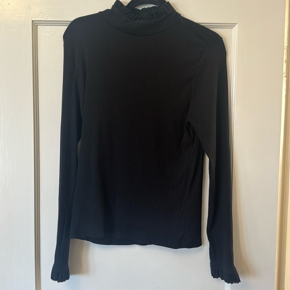 Black top with ruffle detail
